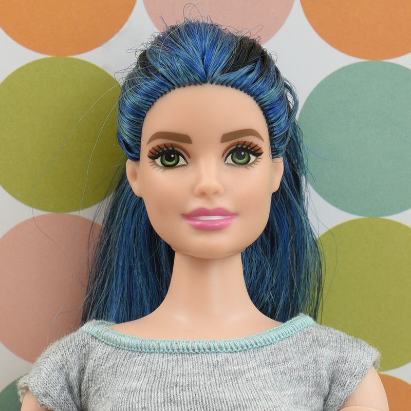 Headshot of a curvy Barbie doll with blue & black hair named Lexi