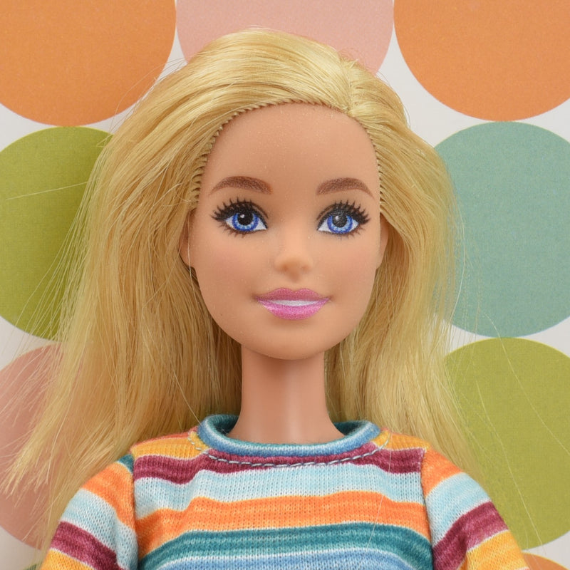 Headshot of a Barbie doll with blonde hair named Harper