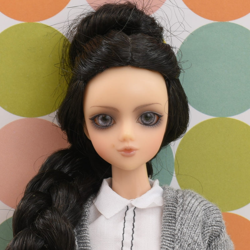 Headshot of a J-Doll with black hair named Cat